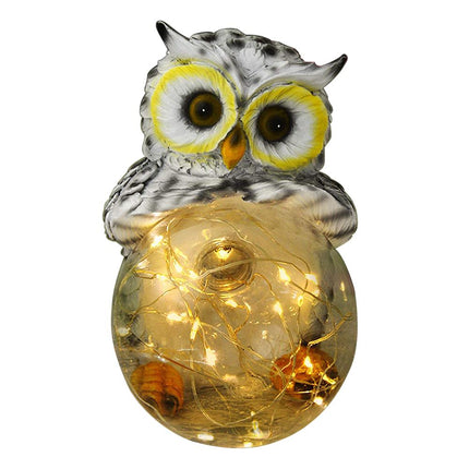 Aurinkoenergialla toimiva pöllö puutarhavalo